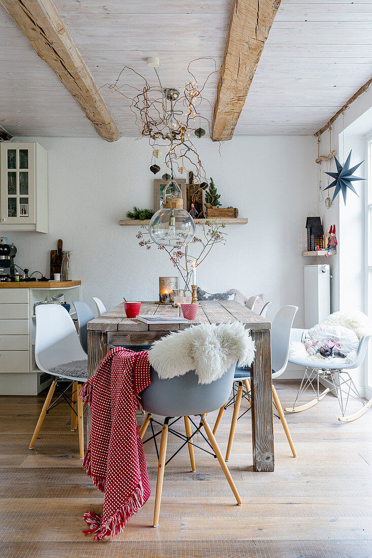 Autumnal decorations in dining area with wooden table and shell chairs