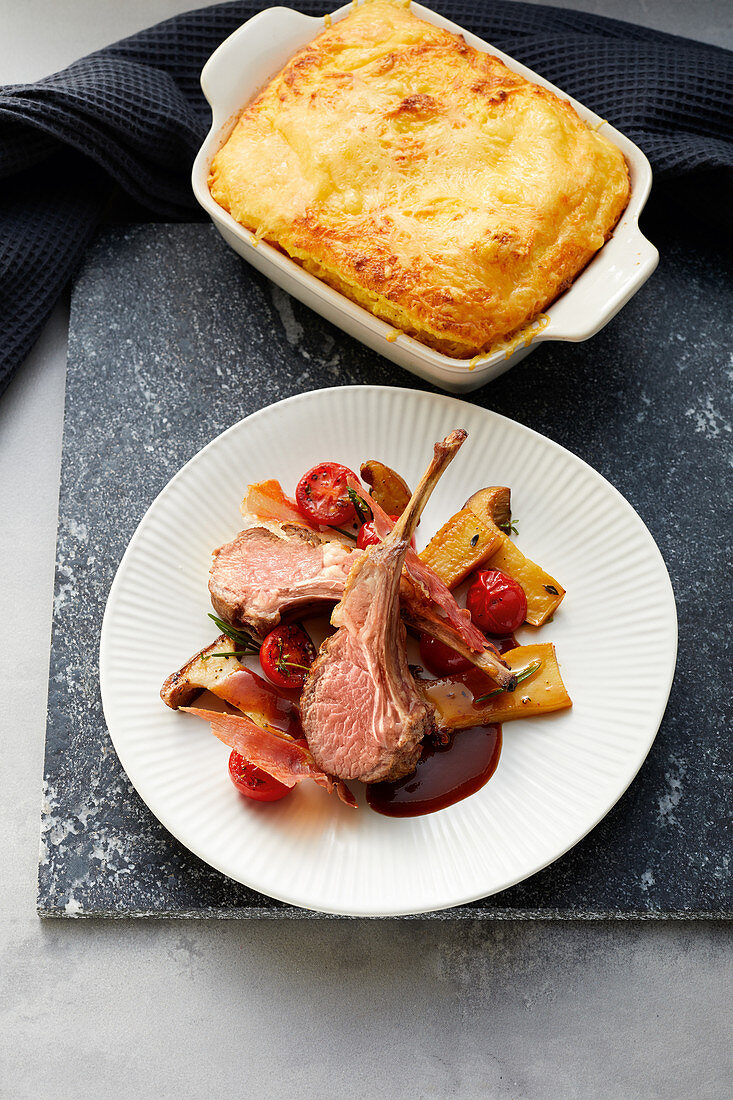 Saddle of lamb on polenta with tomatoes and king trumpet mushrooms