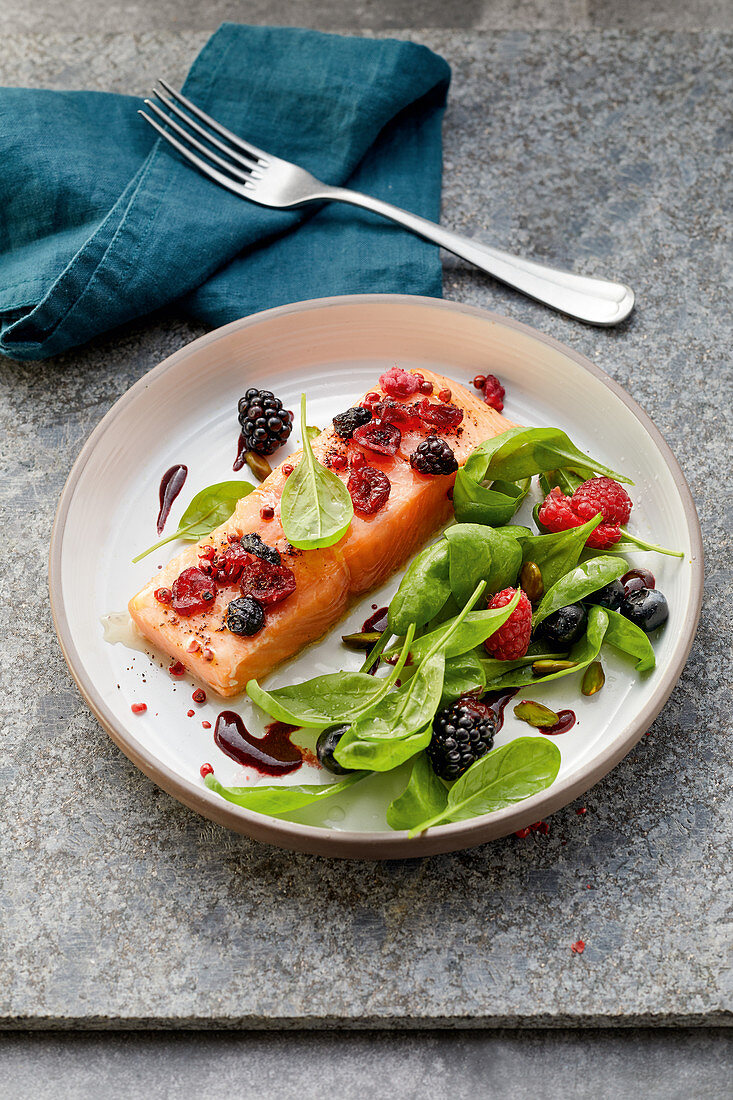 Salmon with a spinach salad and berry vinaigrette