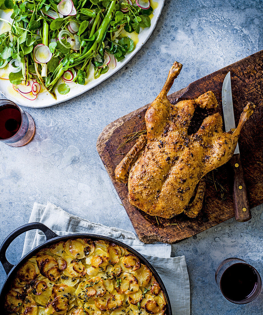 Roast duck with layered potato cake and spring onion, radish and watercress salad