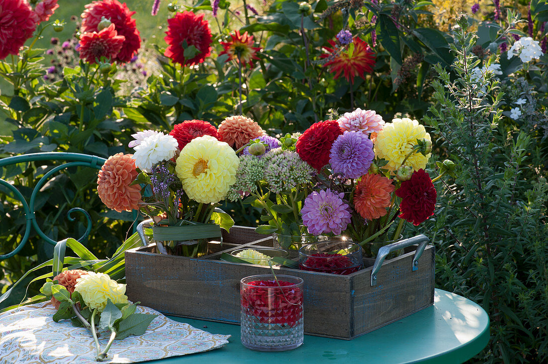 Bouquets of dahlias and stonecrop in a wooden box