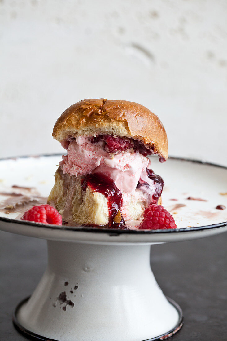 Italian ice cream sandwich (speciality in Sicily) - ice cream with a brioche bun, topped with raspberries and raspberry jam