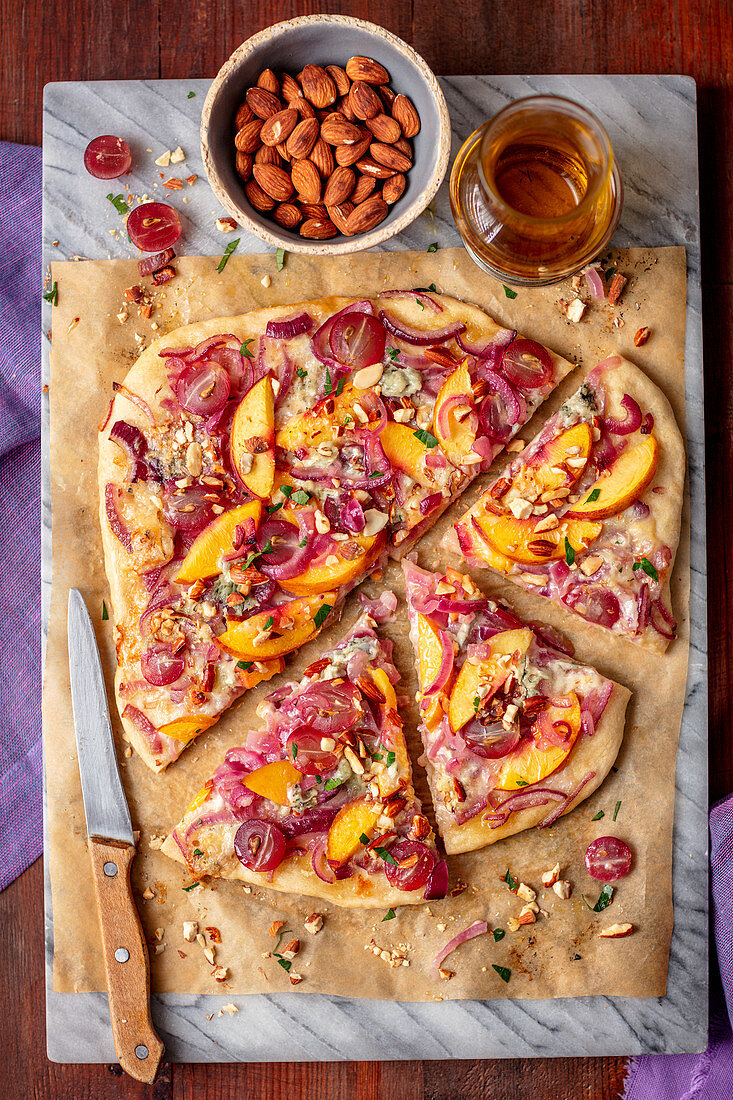 Pizza with caramelized onion, gorgonzola and nectarines