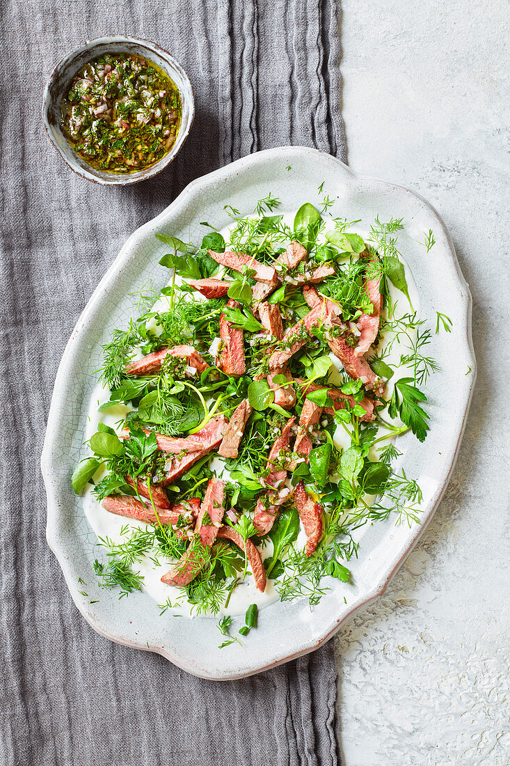 Lamb with soft herb salad and mint sauce dressing