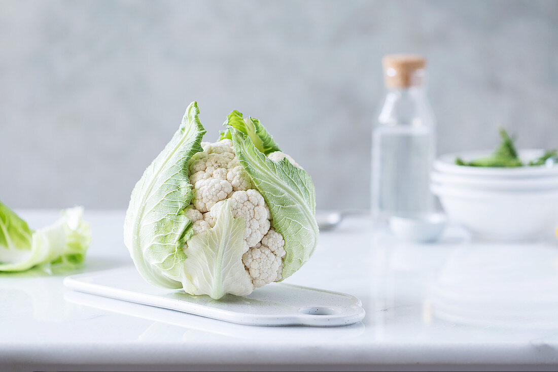 A fresh cauliflower on a kitchen board