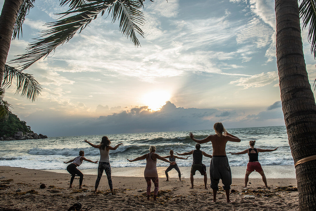 A yoga class on the beach on the island of Koh Phangan, Thailand