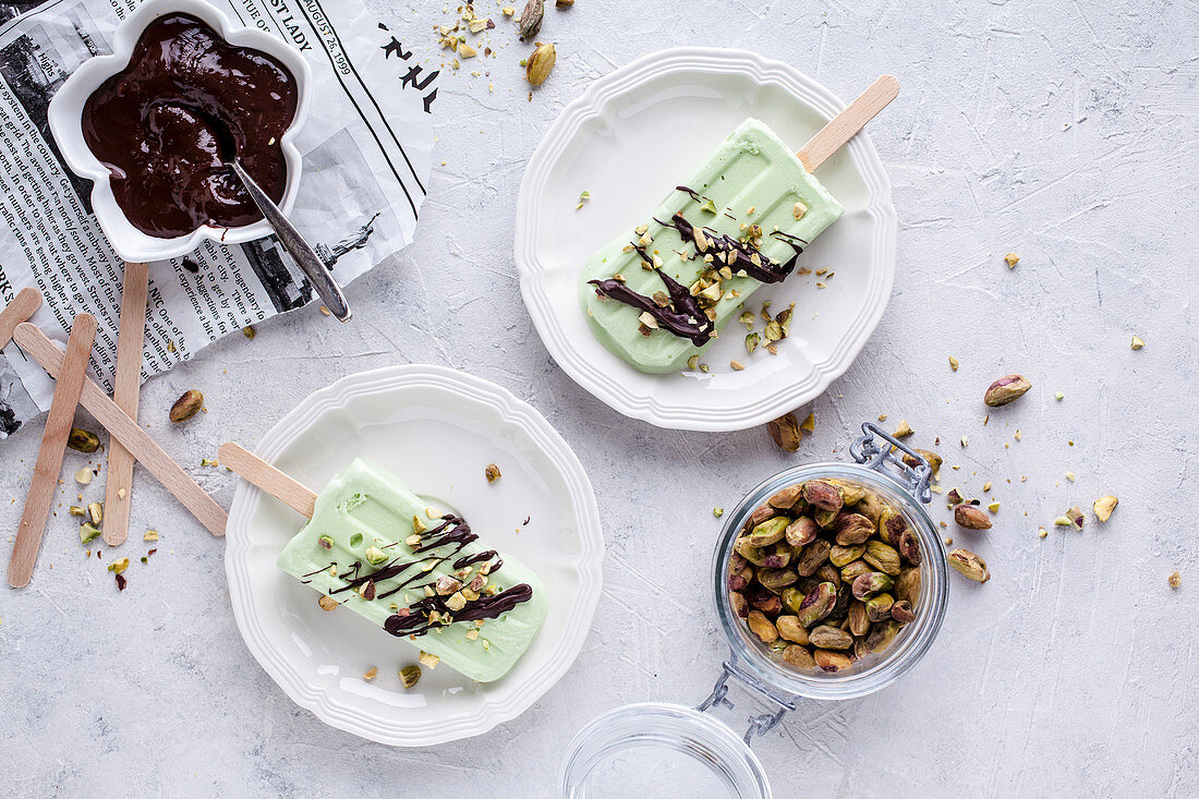 Pistachio popsicles with chocolate and crushed pistachios