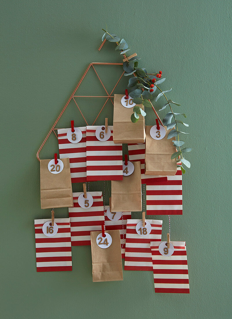 Advent calendar made from red-and-white striped and brown paper bags