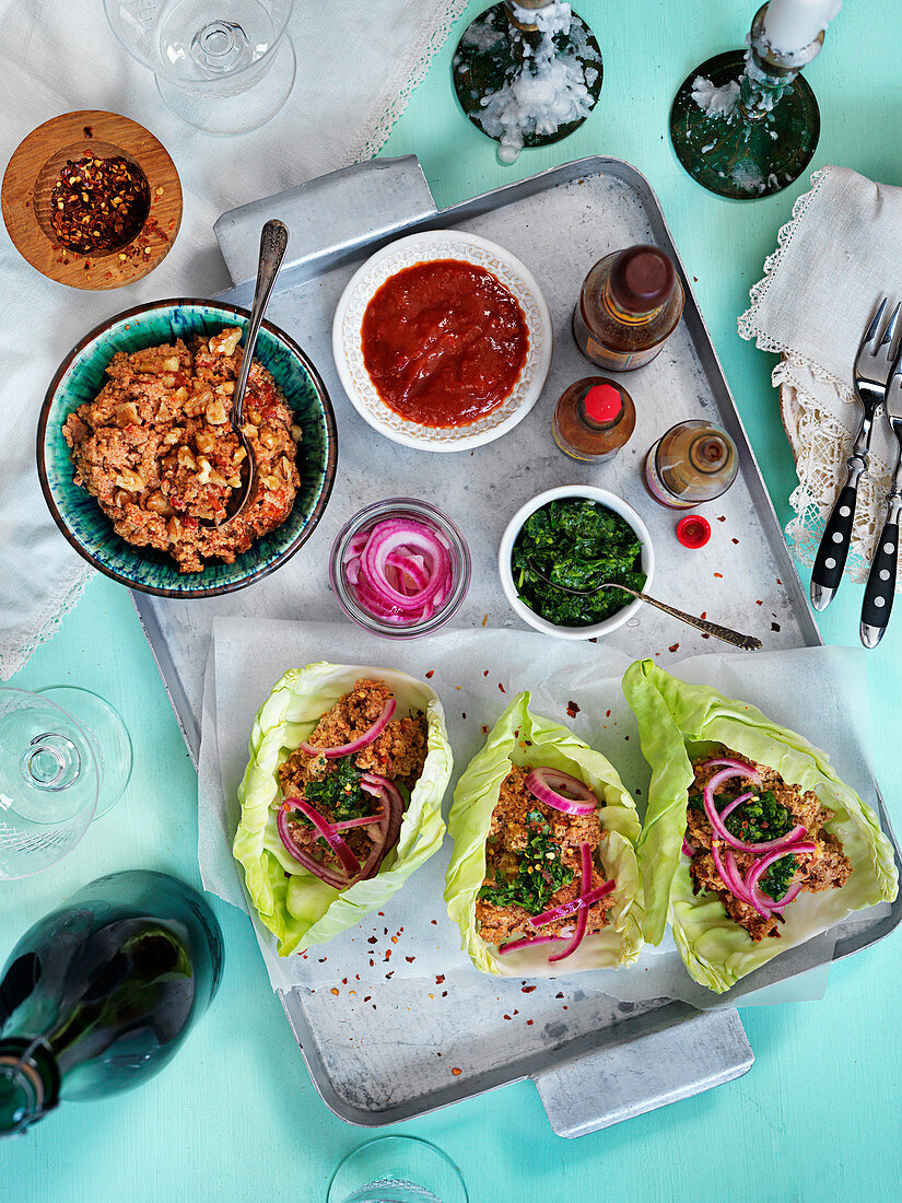 Vegeterian tacos with nuts, pickled red onion, spicy sauces, coriander and chiliflakes