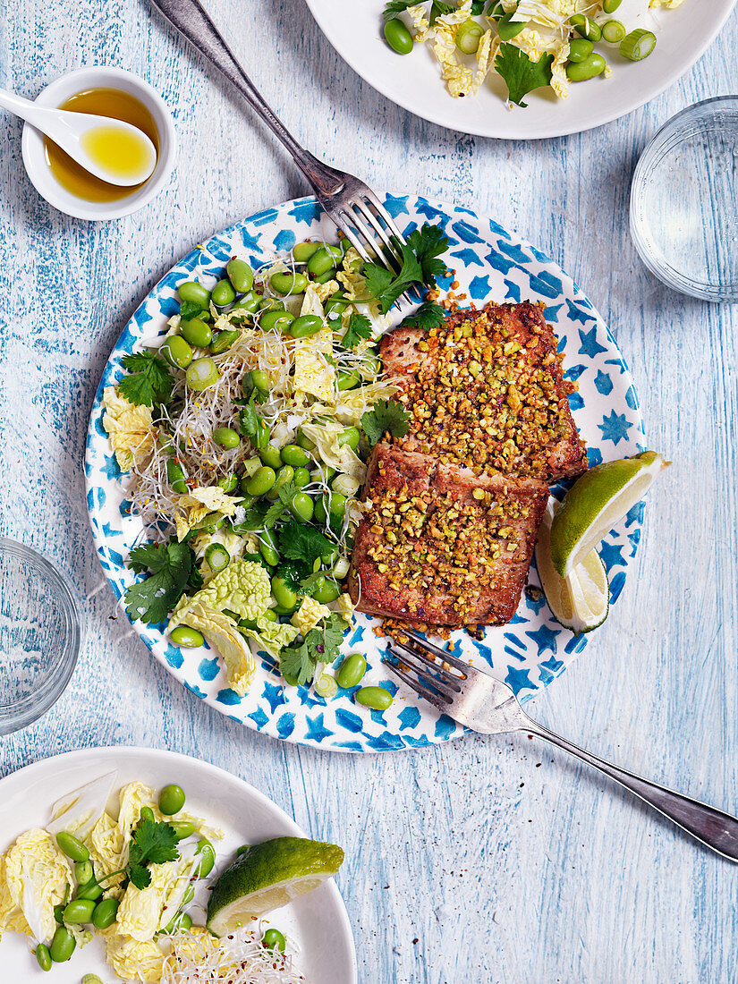 Salat mit mariniertem Tofu, Nüssen, Sojabohnen, Sprossen, Koriander, Lauch und Limetten