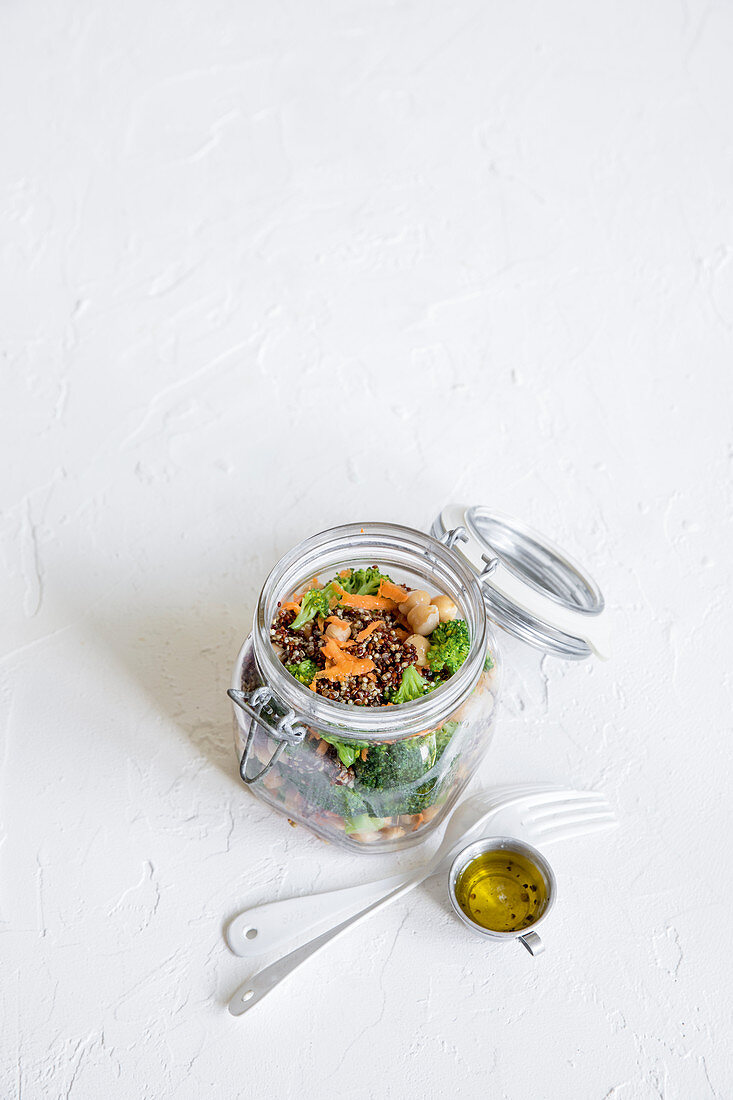 Broccoli salad with quinoa and chickpeas in a storage jar