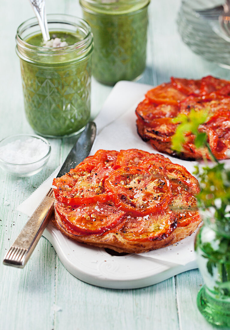 Mini tomato tarts and green soup in jars