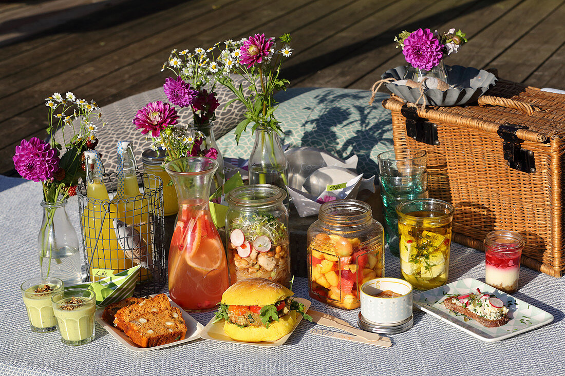 Various drinks and snacks for a summer picnic by a lake
