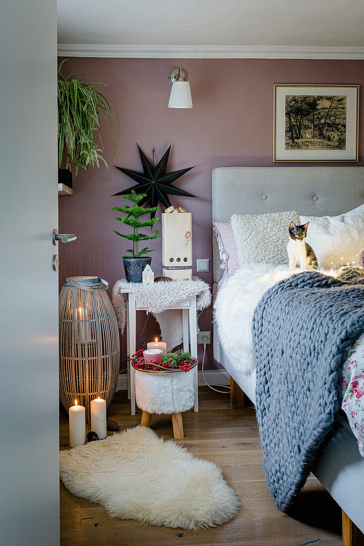 Fur rugs, candles and kitten in cosy bedroom