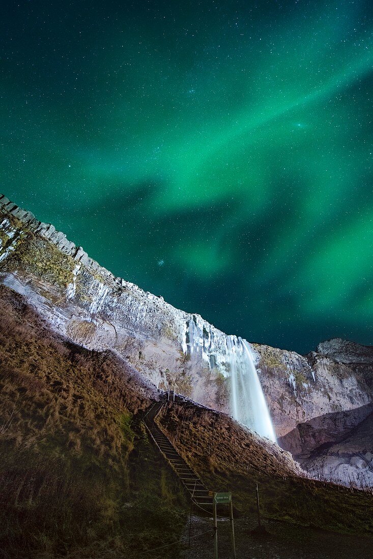 Aurora borealis over a waterfall in Iceland