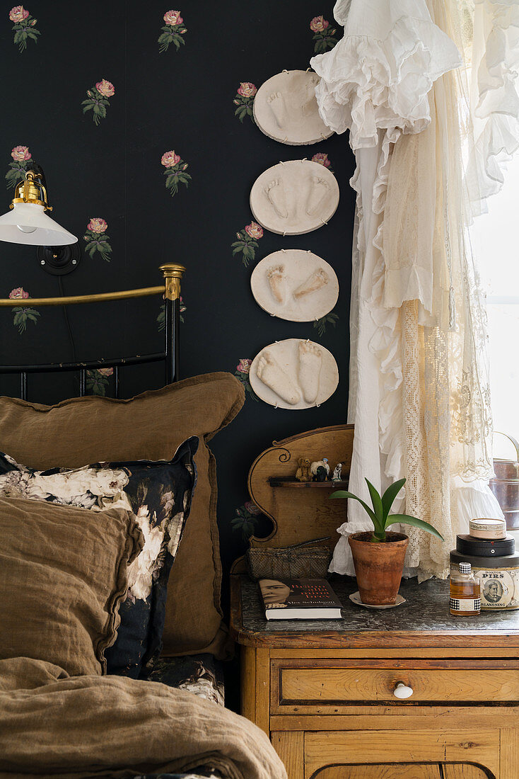 Baby footprints on floral wallpaper on a black background