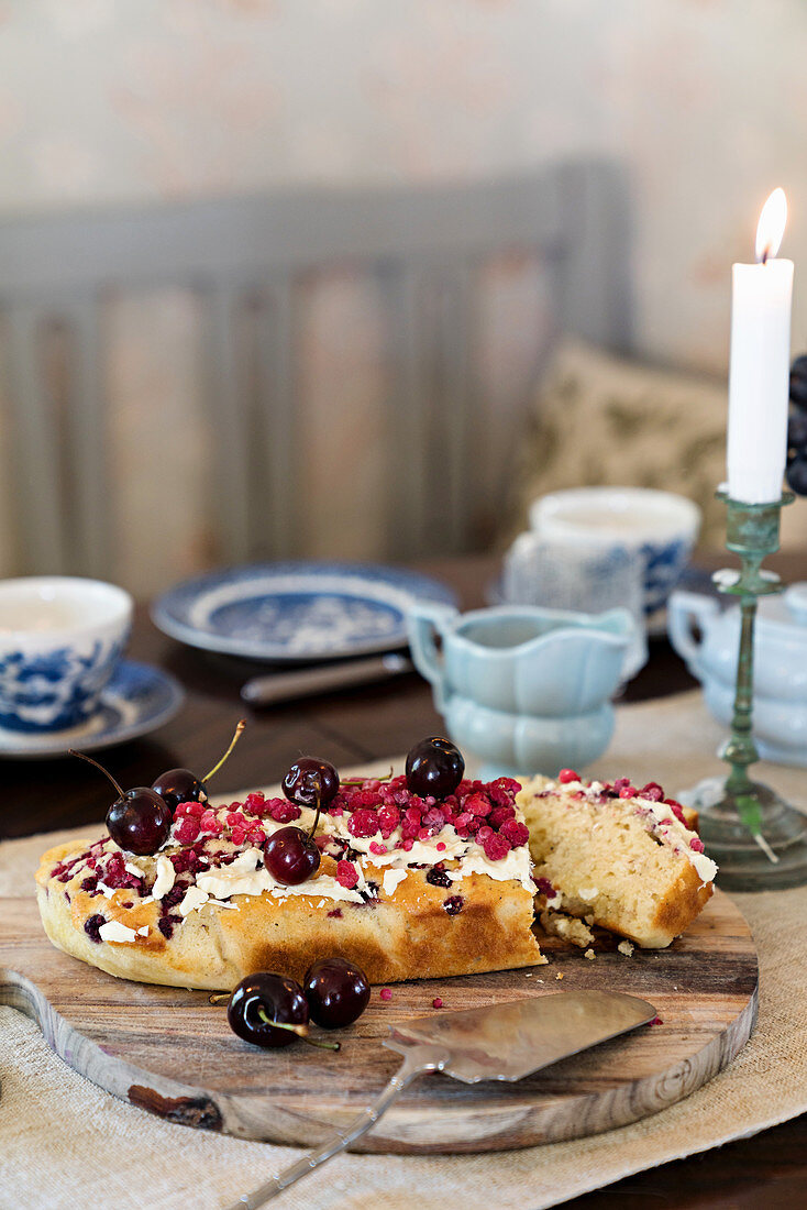 Cherry cake on table set for afternoon coffee