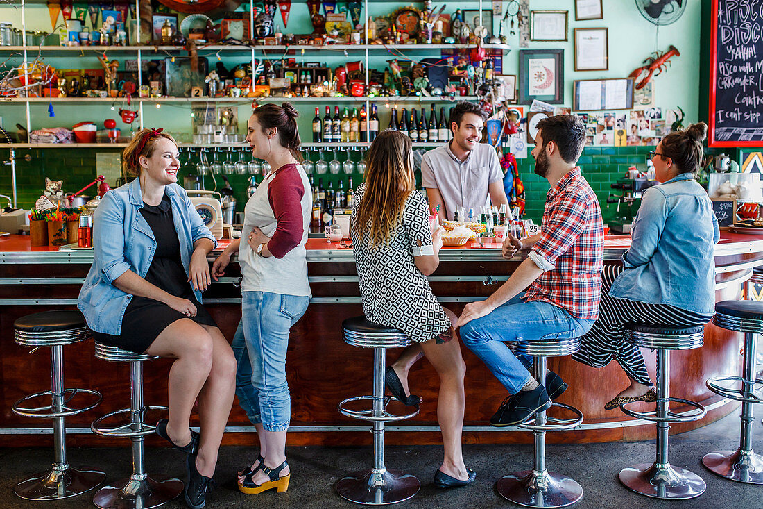 People in 60s diner restaurant