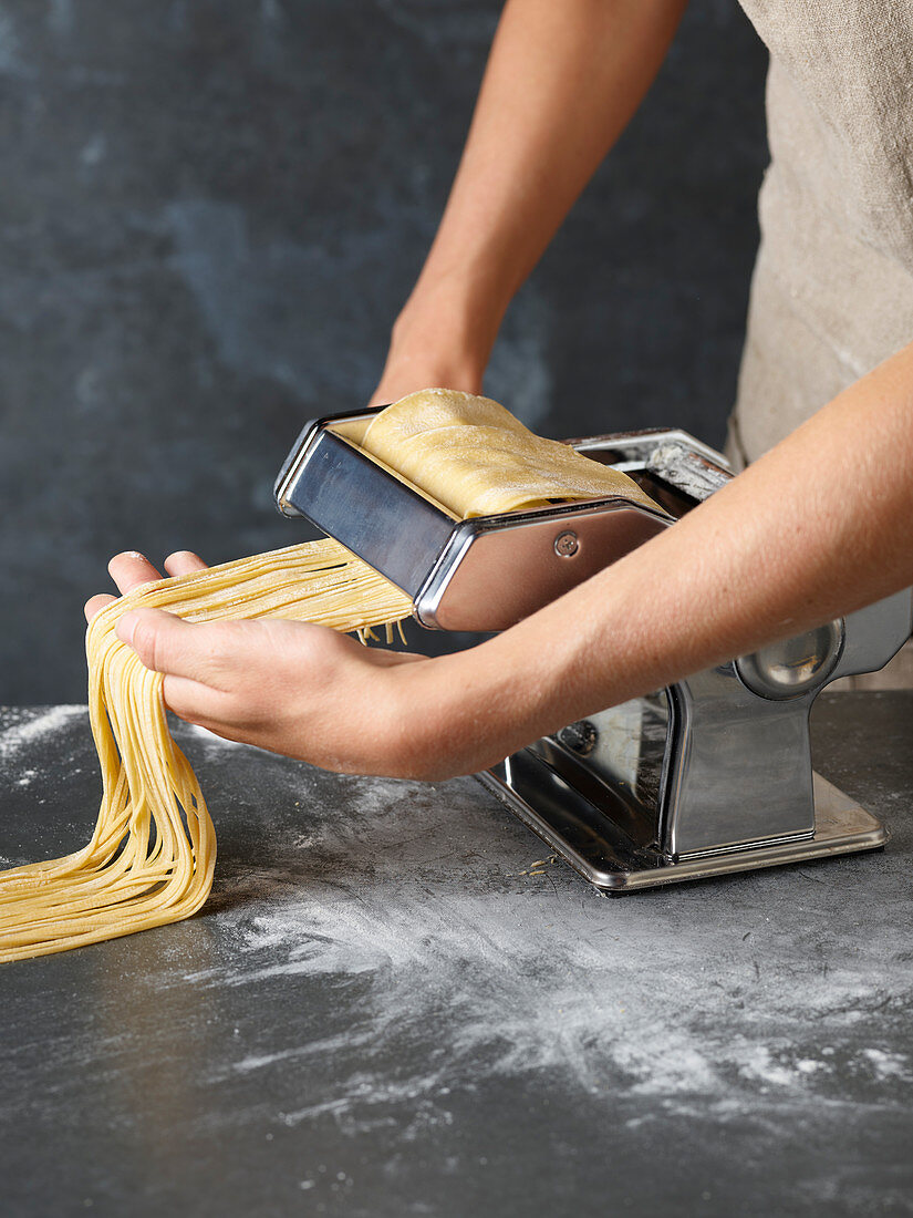 How to make your own pasta: turn pasta dough through a pasta machine