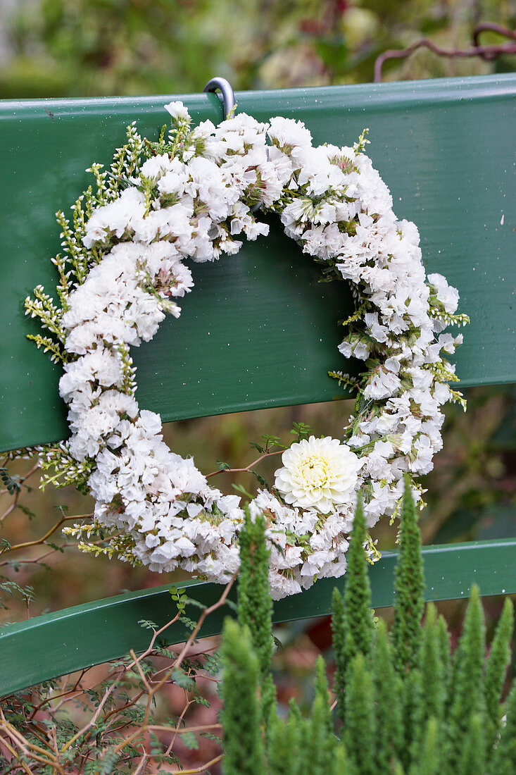 White wreath of sea lavender, dahlia, and common heather