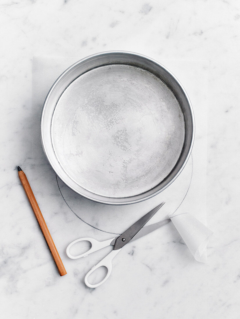 Lining the base of a round cake pan