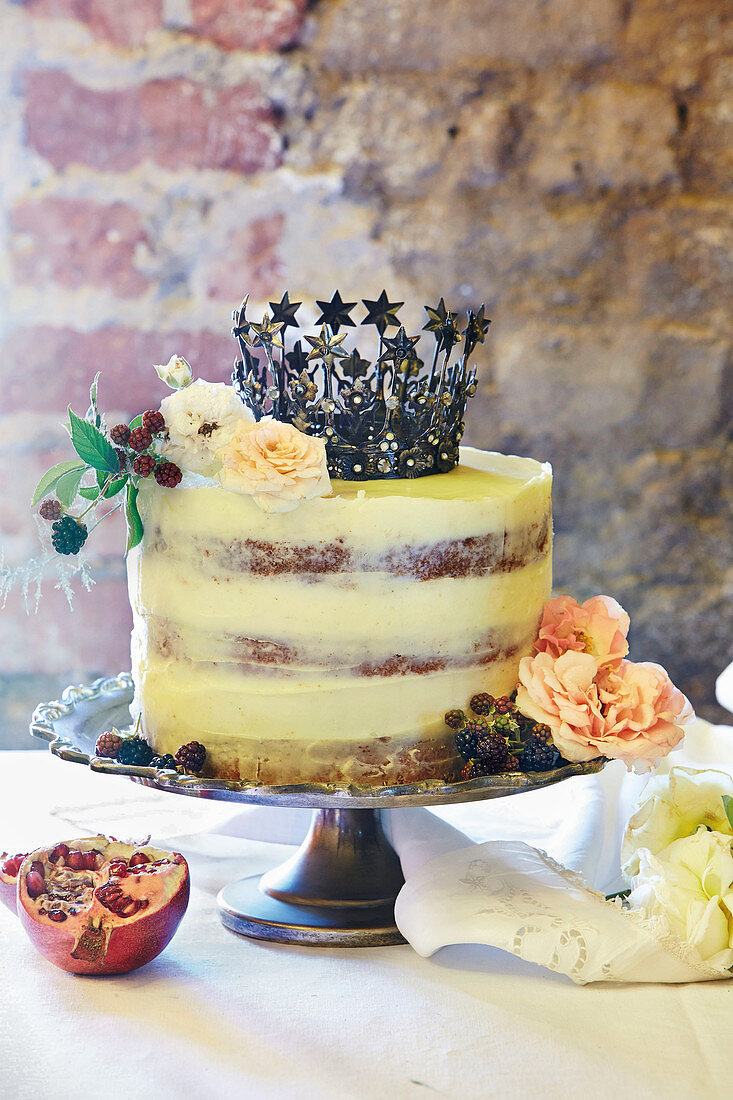 Surprise cake with vanilla buttercream decorated with a crown and flowers
