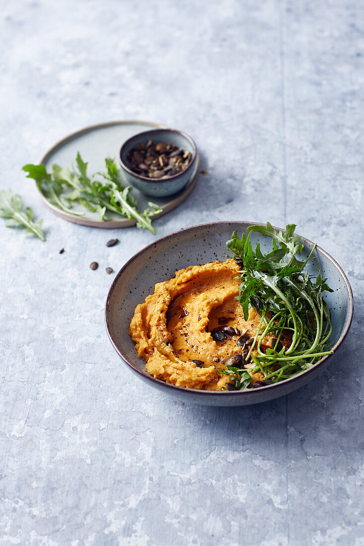 Vegan pumpkin and lentil purée with rocket