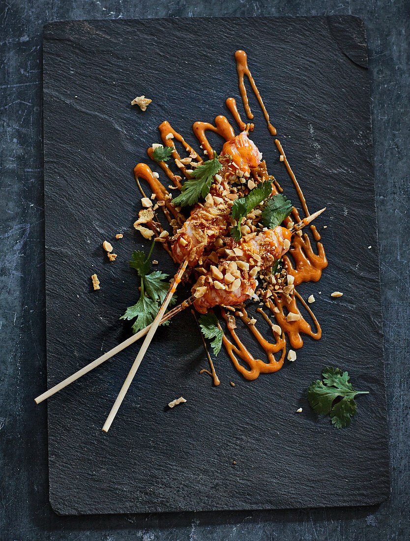Prawn skewers with peanuts, crispy onions and chilli mayonnaise