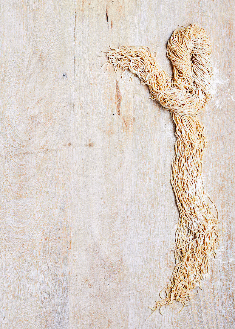 Fresh noodles on wooden background