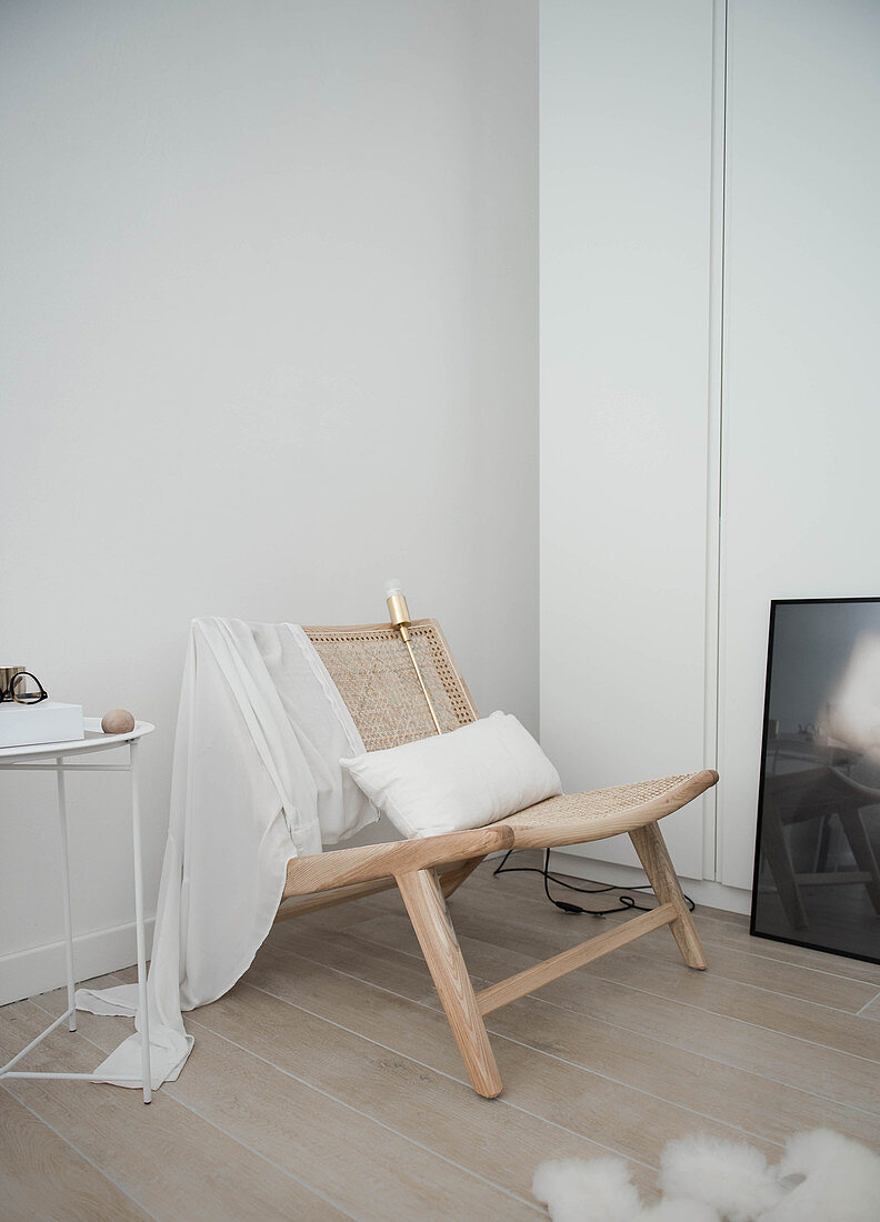 Wooden chair with cane seat and backrest in corner