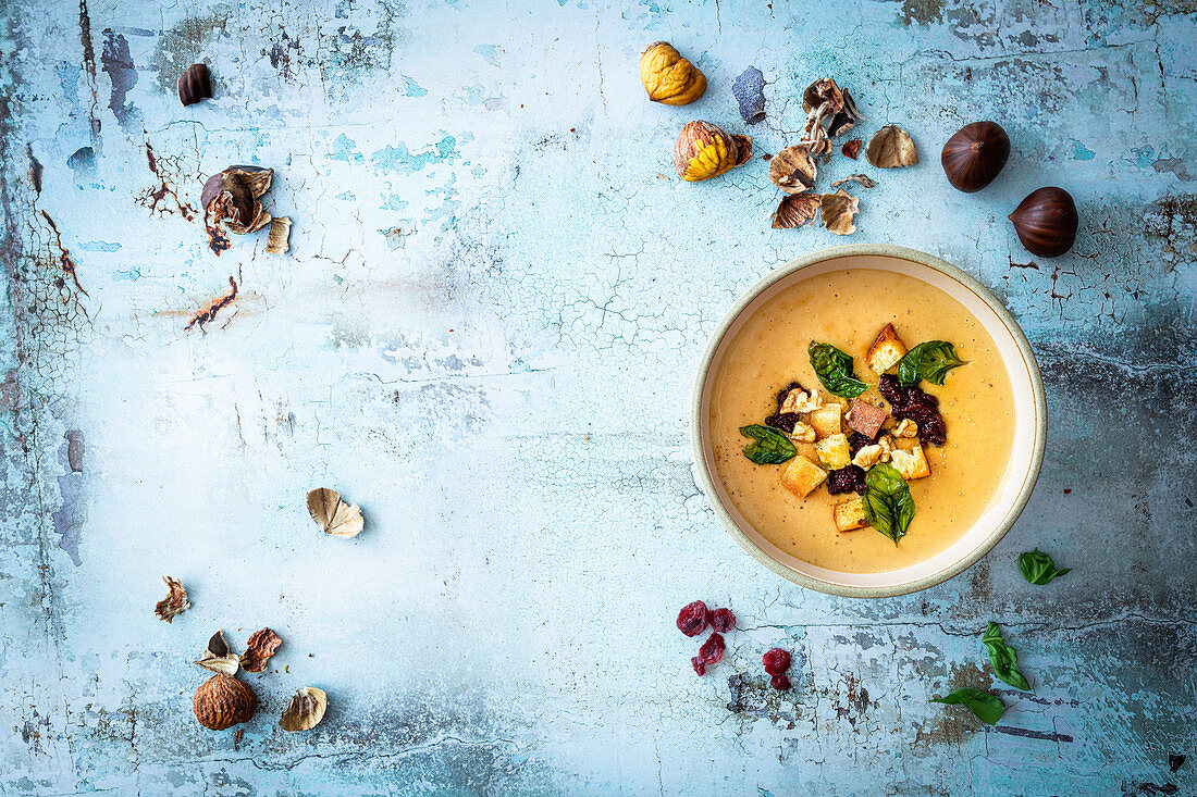 Cream soup with chestnuts and cranberry pesto