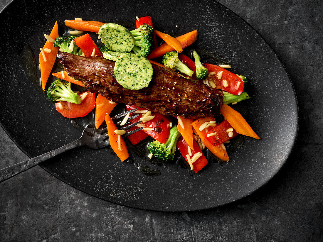 Venison fillet with colourful honey-glazed vegetables and herb butter