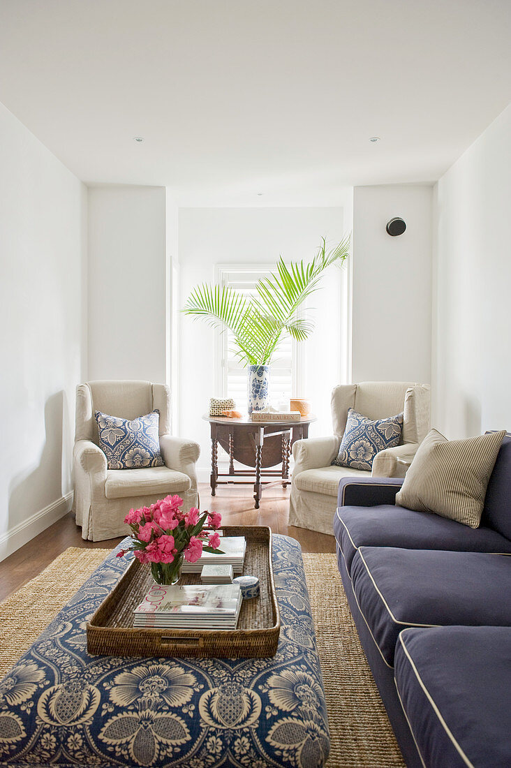 Upholstered furnishings in blue and ecru in white living room