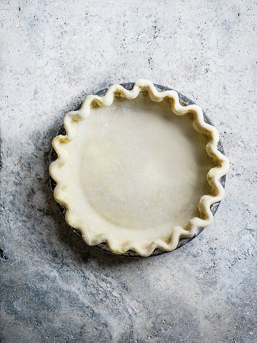 Uncooked pie dough in case