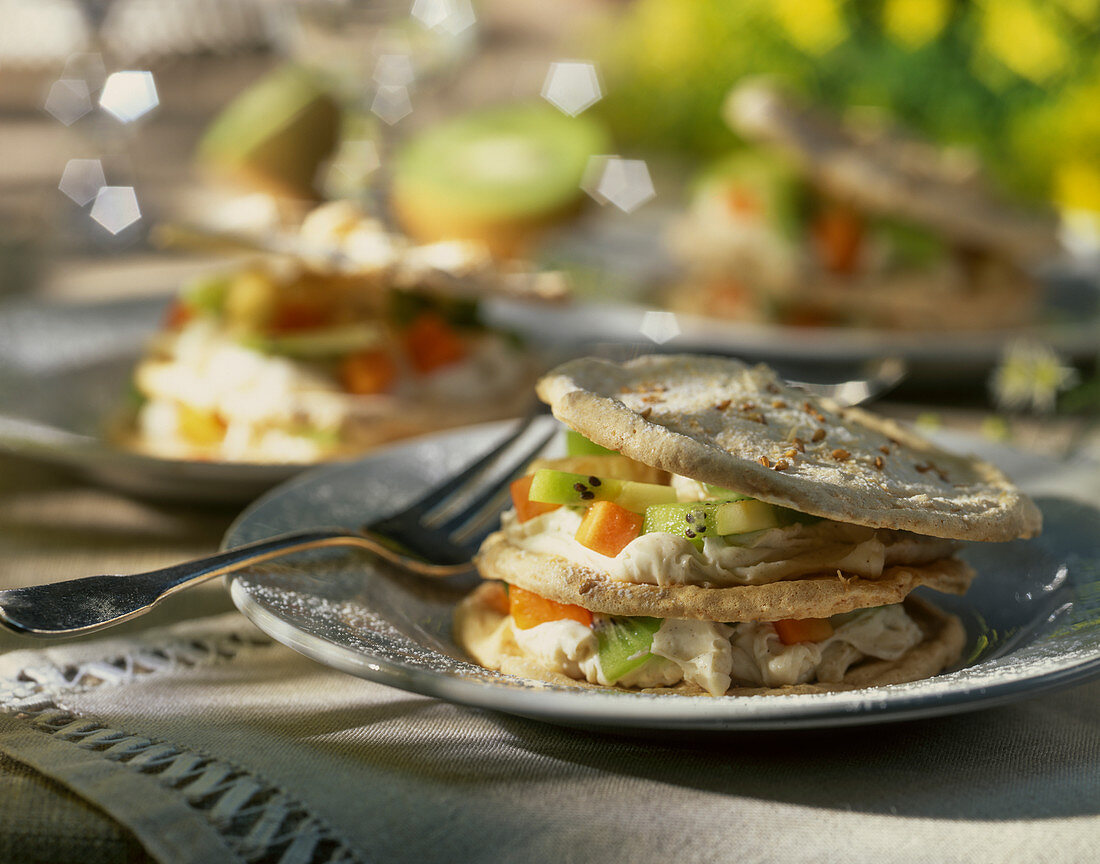 Layered pastries with meringue, mascarppone and exotic fruit