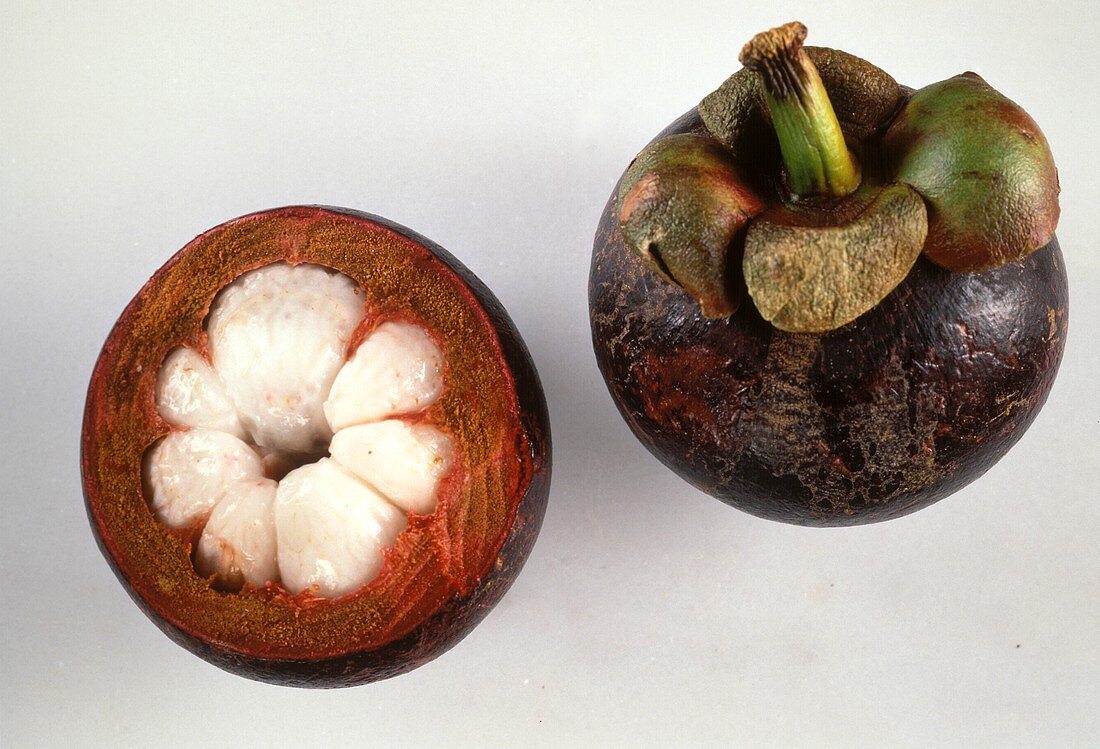 Whole and half mangosteen