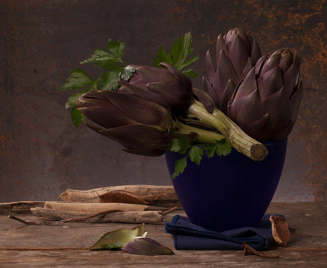Artichokes and parsley in a blue vase