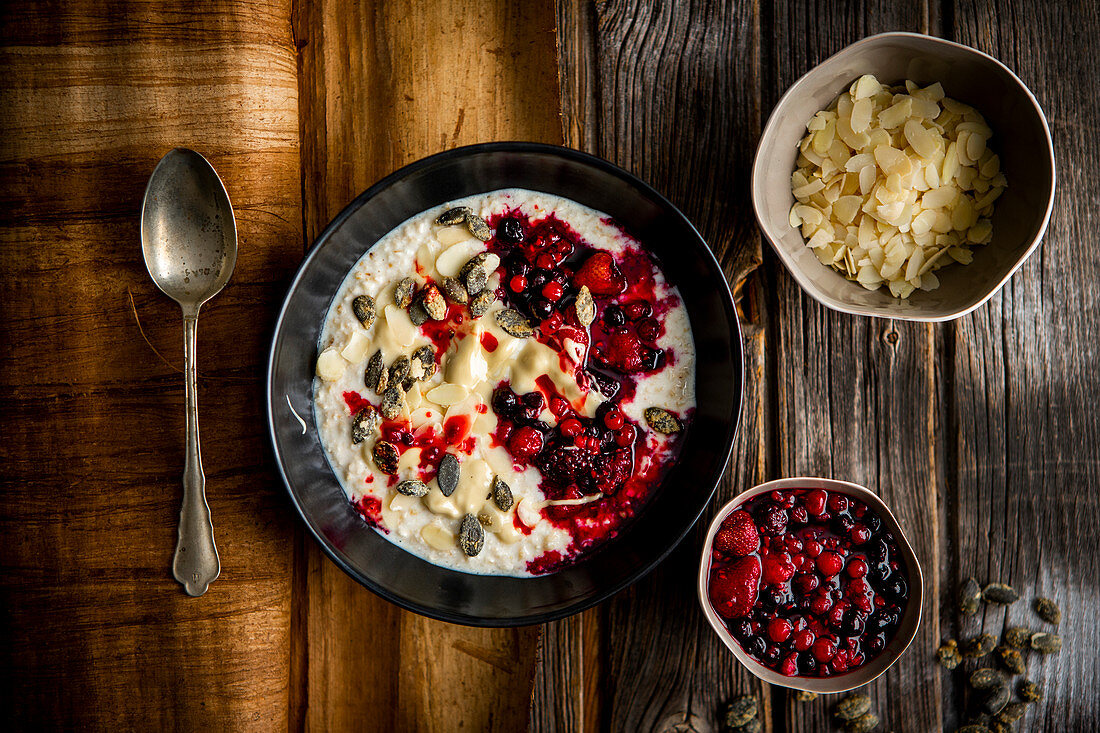 Porridge almond butter and whiskey candied pumpkin seeds berries