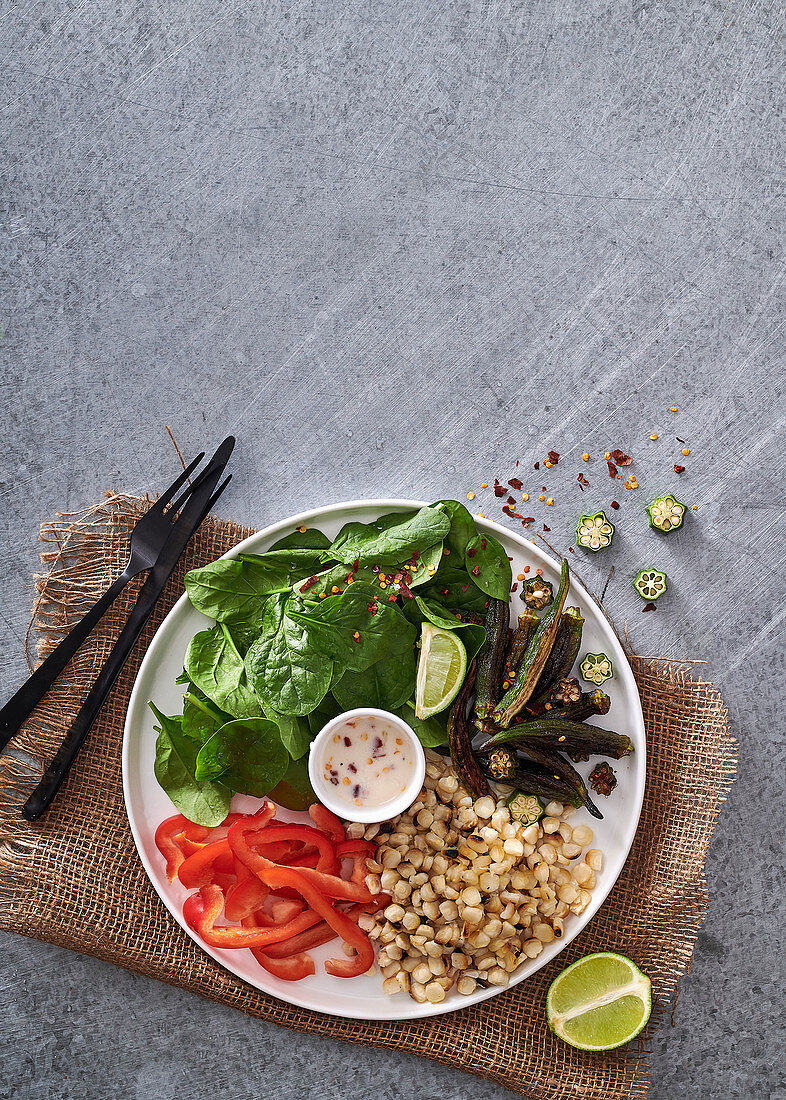 Salat mit Okra, gegrilltem Mais, Paprika, Spinat und Thai-Kokos-Limetten-Dressing