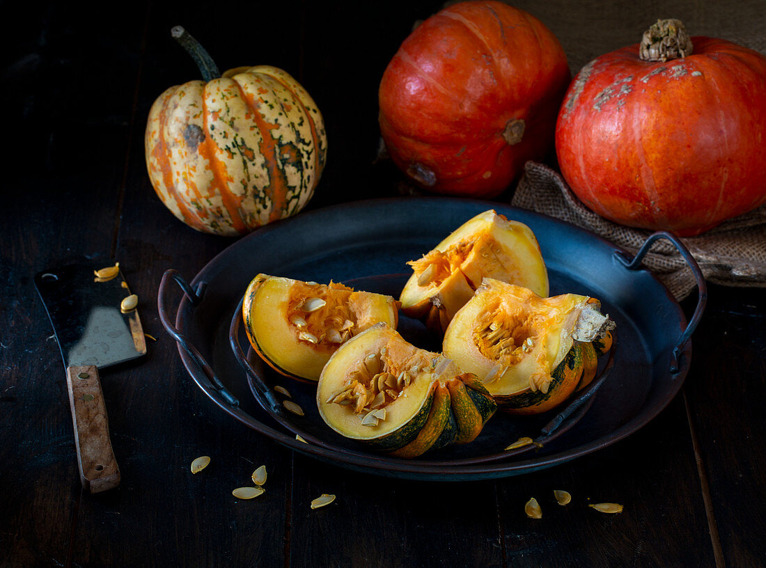 Pumpkins and squashes with squash cut open