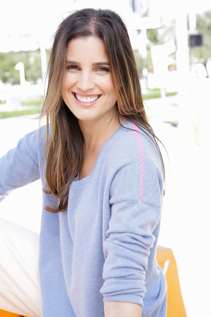 A young woman wearing a lilac jumper