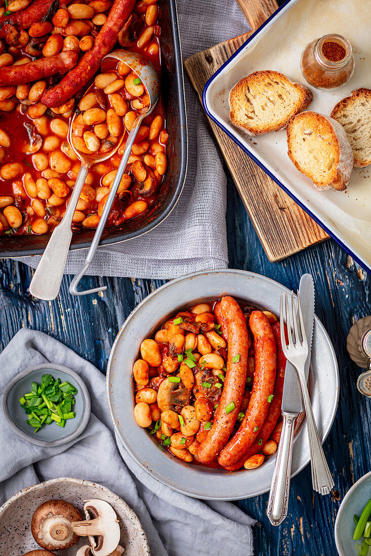 Sausages baked with bean, mushrooms and tomato sauce