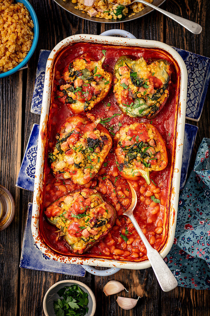 Pepper stuffed with lentils and ham, baked with white beans in tomato sauce