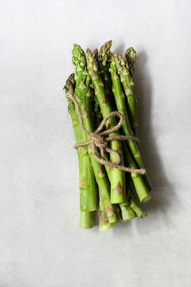 A bunch of fresh asparagus tied with string