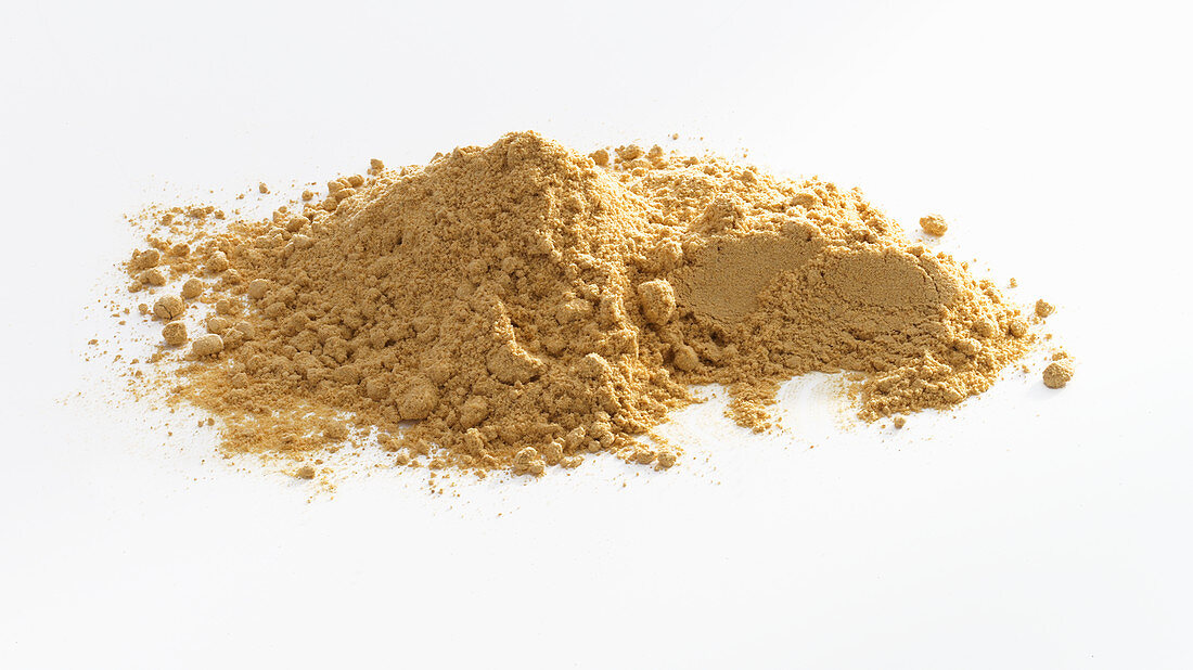 A pile of ginger powder against a white background