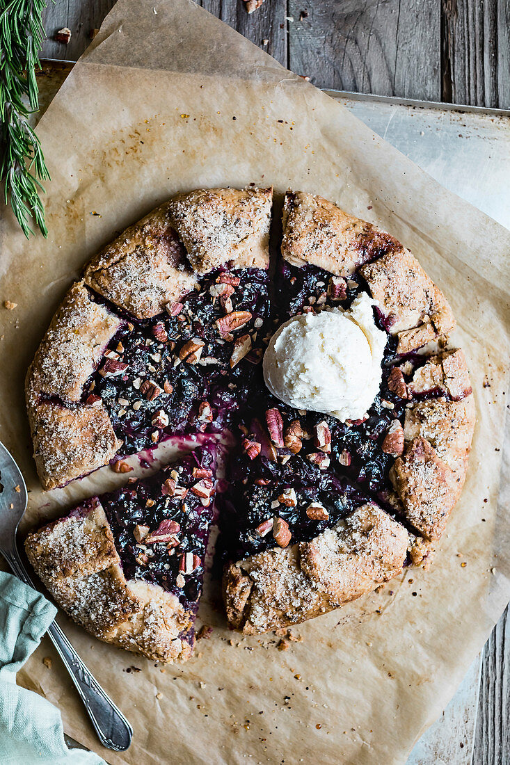 An autumnal galette with pears and blue grapes served with vanilla ice cream