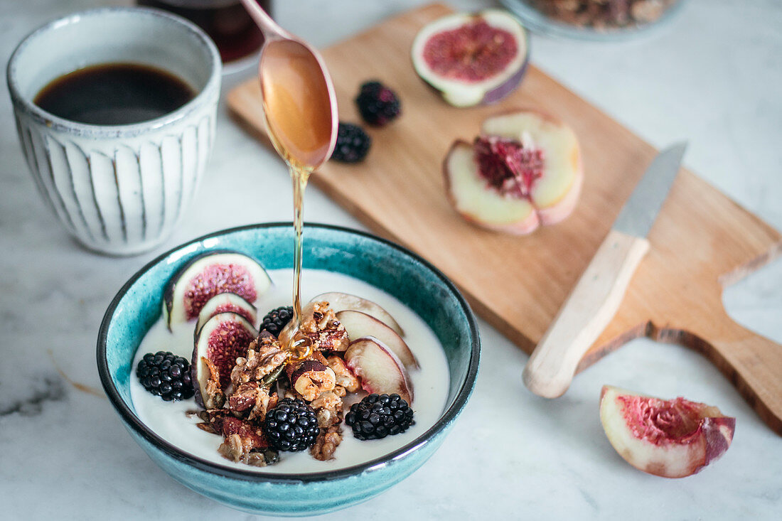 Yogurt with fruits, granola and honey