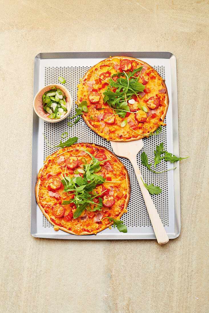 Tortilla pizza with bacon, tomatoes and arugula