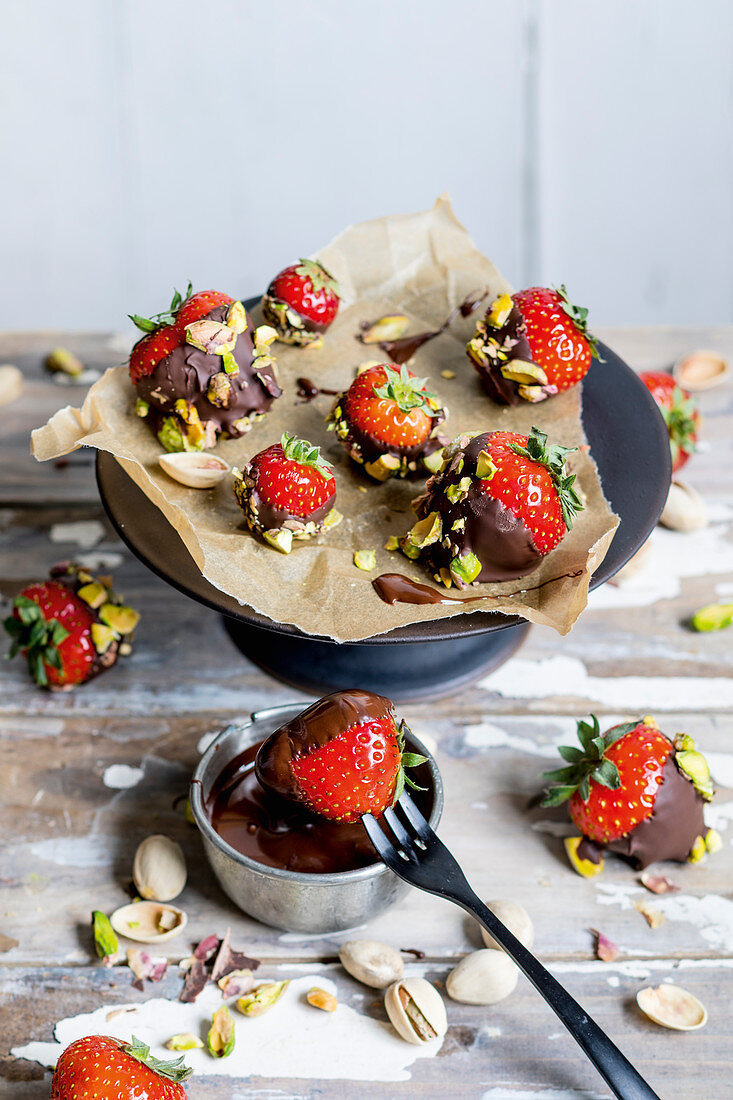 Chocolate and pistachio coated strawberries (keto cuisine)