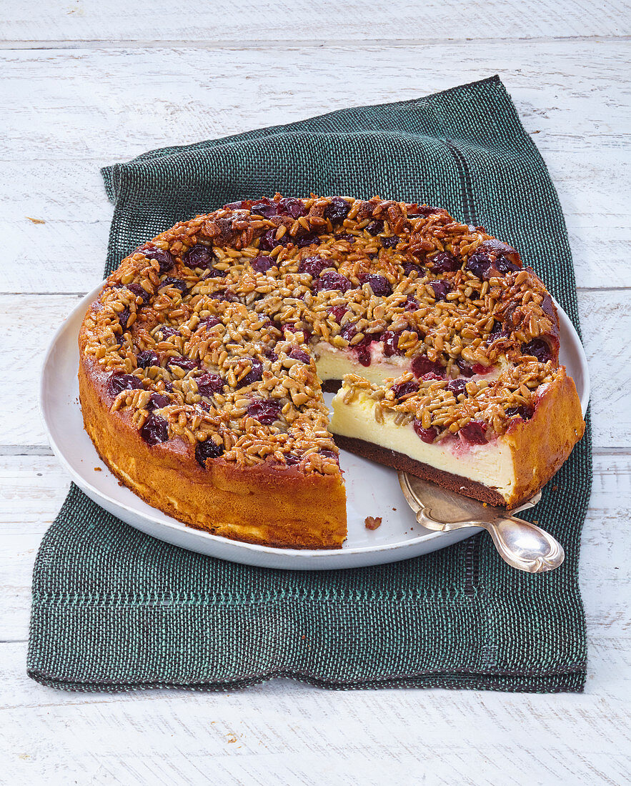 Cheesecake with sour cherries and sunflower crunch topping